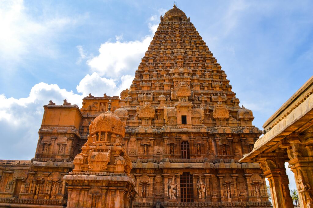 Stunning view of the ancient Brihadeeswarar Temple under a bright blue sky in Thanjavur, Tamil Nadu.